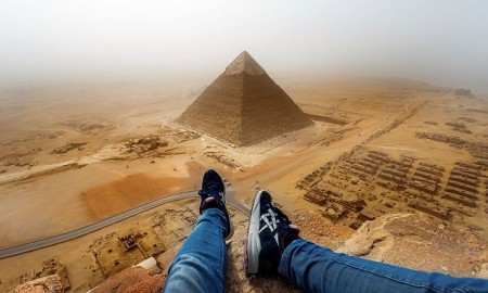 PIC BY ANDREJ CIESIELSKI / CATERS NEWS - (PICTURED: Andrej Ciesielski captured this incredible view from the top of the Cheops Pyramid in Cario, Egypt.) - This man certainly chose a peak-time to give the pyramids a climb! Daring Andrej Ciesielski, 18, from Munich, travelled to Cairo, Egypt, with the intention of climbing the Cheops Pyramid, one of the three mammoth tombs at Giza. Although it is illegal to climb the 146 metre high construction, Andrej threw caution to the wind and managed to make the climb in broad daylight, with a time of eight minutes. Before the stunt, Andrej sought out the locals for any insider knowledge that might help him during the climb and made sure he did it as quickly as possible to avoid getting caught early on. But despite making quick headway, Andrej was eventually caught and taken to a police station for questioning after he climb back from the dizzying heights. SEE CATERS COPY.