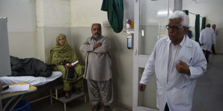 In this photograph taken on August 3, 2016, Pakistani doctor Adibul Rizvi, head of the Sindh Institute of Urology and Transplantation (SIUT), walks to visit his patients in Karachi. Camped on the baking concrete outside a gleaming transplant centre, Karachi's sick have come from miles around in desperate hope for a last chance at life. There, Dr Adibul Rizvi provides free medical care to hundreds of thousands of people each year, providing a much-needed alternative to Pakistan's public health sector, which critics dismiss as chaotic, corrupt and vastly under-resourced. / AFP / ASIF HASSAN / To go with 'Pakistan-Health-Transplant-Social' FEATURE by Sarah Titterton (Photo credit should read ASIF HASSAN/AFP/Getty Images)