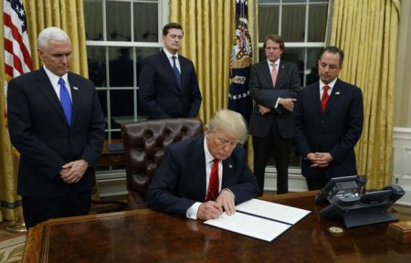 648x415_president-donald-trump-flanked-by-vice-president-mike-pence-and-chief-of-staff-reince-priebus-signs