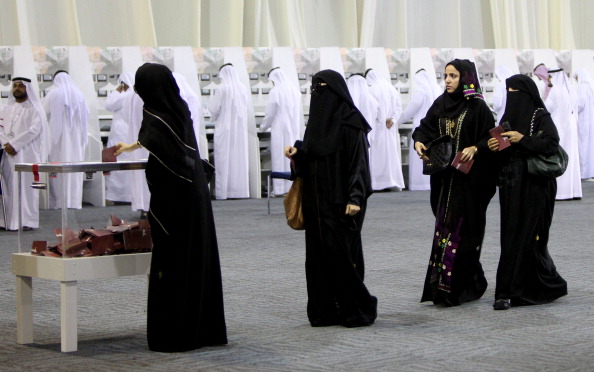 Emirati women cast their votes in a ballot box at a polling centre at a conventions complex in the Gulf emirate of Dubai on September 24, 2011, as voters chosen by the rulers of the United Arab Emirates took part in only the second-ever polls to elect half of the members of the powerless Federal National Council. AFP PHOTO/MARWAN NAAMANI (Photo credit should read MARWAN NAAMANI/AFP/Getty Images)