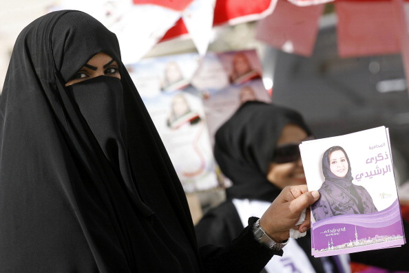 A Kuwaiti woman supporting candidate Zekra al-Rashidi holds campaign flyers outside a polling station in Kuwait City on February 2, 2012. Kuwaitis are voting in a snap poll to elect the fourth parliament in less than six years with unofficial polls showing the Islamist-led opposition in the lead. AFP PHOTO/YASSER AL-ZAYYAT (Photo credit should read YASSER AL-ZAYYAT/AFP/GettyImages)