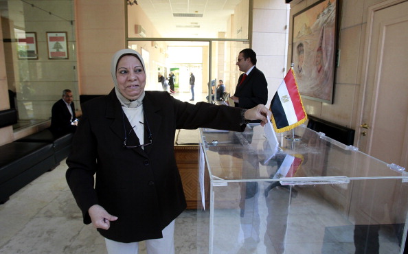 A Muslim Egyptian woman residing in Lebanon votes on a divisive draft constitution at the Egyptian embassy in Beirut on December 12, 2012. The expatriate vote -- itself postponed for days -- began with the polling of more than 500,000 Egyptians at embassies and consulates in 150 countries, Egypt's official news agency MENA said as the country's charter pitted Islamist allies of President Mohammed Morsi against secular-leaning foes in rival rallies that clashed last week. AFP PHOTO/ANWAR AMRO (Photo credit should read ANWAR AMRO/AFP/Getty Images)
