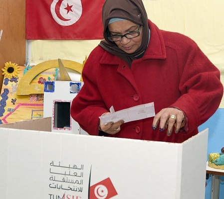 A Tunisian woman casts her vote on December 21, 2014 at a polling station in Tunis. The second round vote pits 88-year-old favourite Beji Caid Essebsi, leader of the anti-Islamist Nidaa Tounes party, against incumbent Moncef Marzouki, who held the post through an alliance with the moderate Islamist movement Ennahda. AFP PHOTO / FETHI BELAID (Photo credit should read FETHI BELAID/AFP/Getty Images)