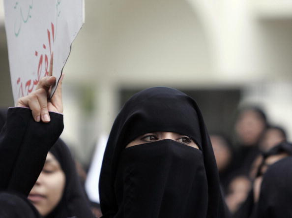 Manama, BAHRAIN: Bahraini women take part in a demonstration in Manama 24 November 2006 to call for a probe into an alleged plot aimed at marginalising the Shiite majority ahead of the November 25 legislative vote. The protesters, mainly Shiites, marched towards the prime minister's office behind a dozen Shiite clerics, chanting slogans demanding the resignation of the government. They also called for an inquiry into a reported plot to preserve Sunni Muslim dominance in parliamentary and municipal elections. AFP PHOTO/KARIM SAHIB (Photo credit should read KARIM SAHIB/AFP/Getty Images)